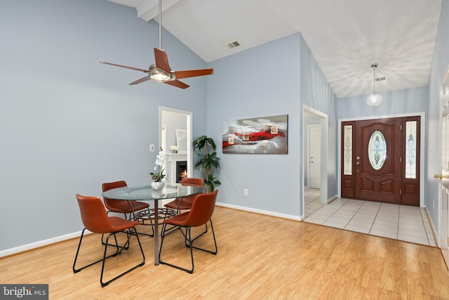 foyer with light wood-type flooring, beam ceiling, ceiling fan, and high vaulted ceiling