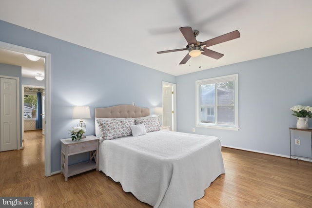 bedroom with ceiling fan and hardwood / wood-style flooring