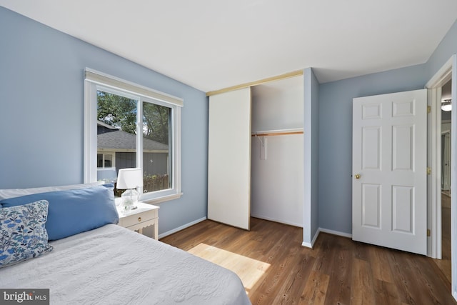 bedroom featuring dark hardwood / wood-style floors and a closet