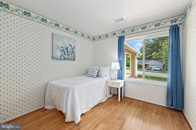 bedroom with wood-type flooring