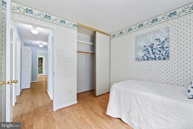 bedroom featuring light wood-type flooring and a closet