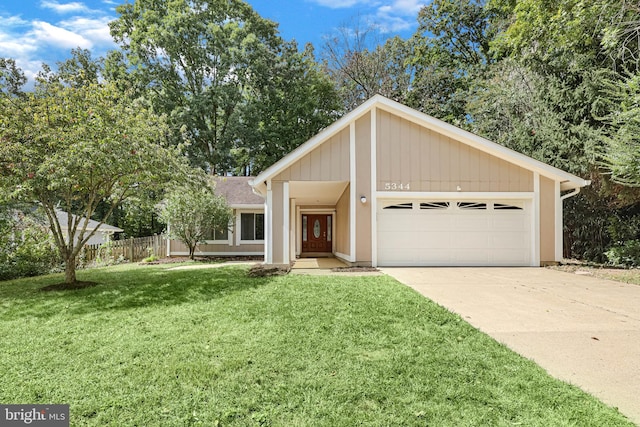 ranch-style house featuring a front yard and a garage