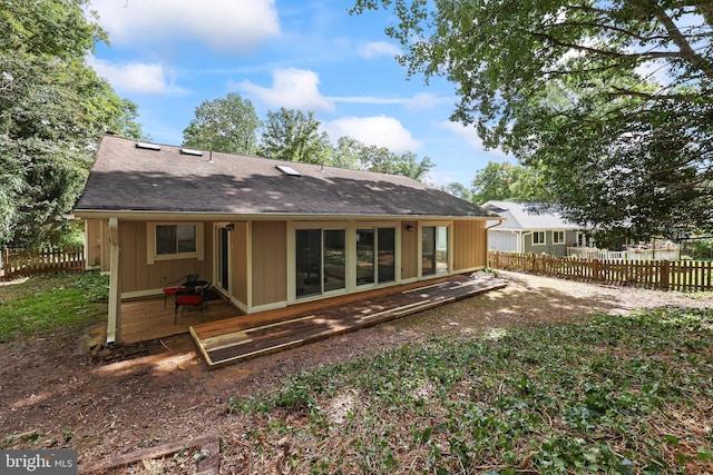 back of house with a deck