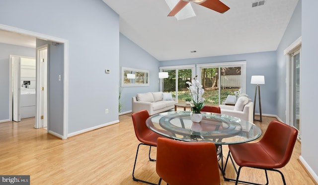 dining room featuring ceiling fan, light hardwood / wood-style floors, and high vaulted ceiling