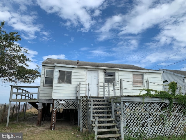 rear view of property featuring a deck