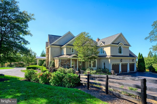 view of front of property with a garage and a front lawn