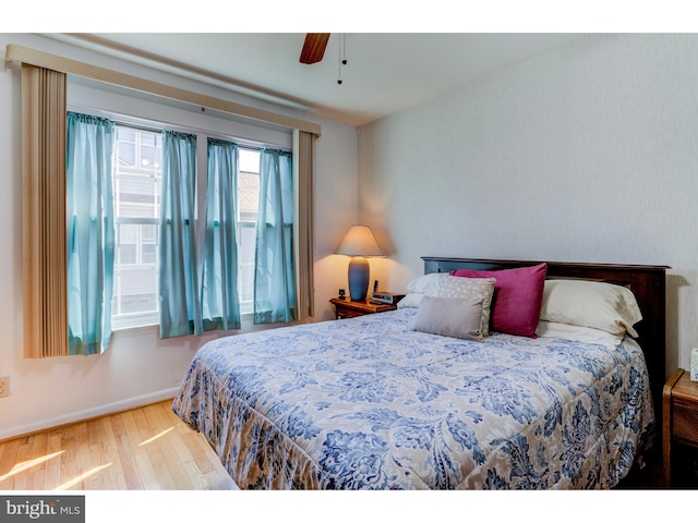 bedroom with ceiling fan and hardwood / wood-style flooring