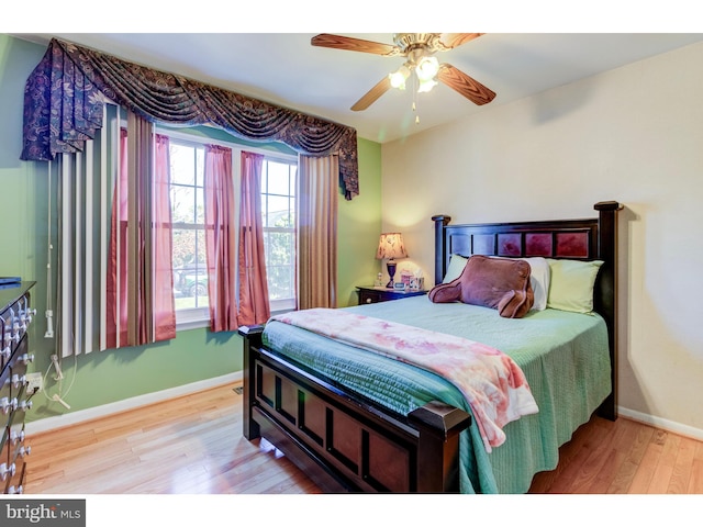 bedroom with ceiling fan and hardwood / wood-style floors