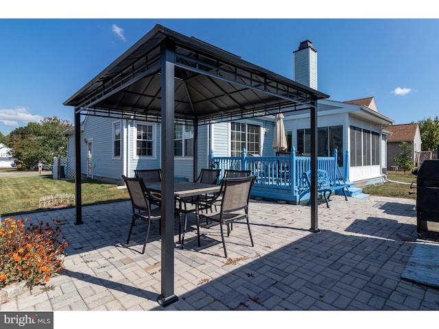 view of patio featuring a gazebo and a sunroom