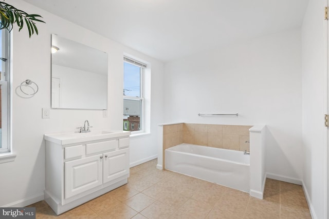 bathroom with tile patterned floors, vanity, and a bathtub