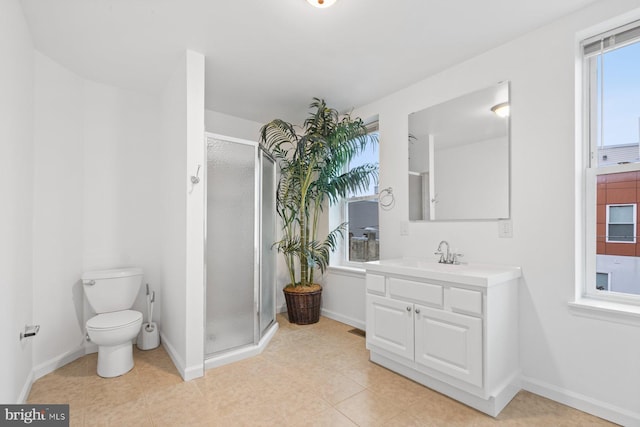 bathroom featuring vanity, toilet, and a shower with door