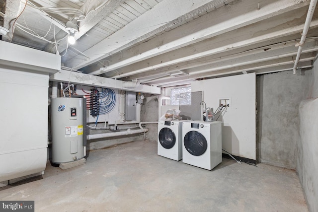 basement with water heater, electric panel, and washing machine and clothes dryer