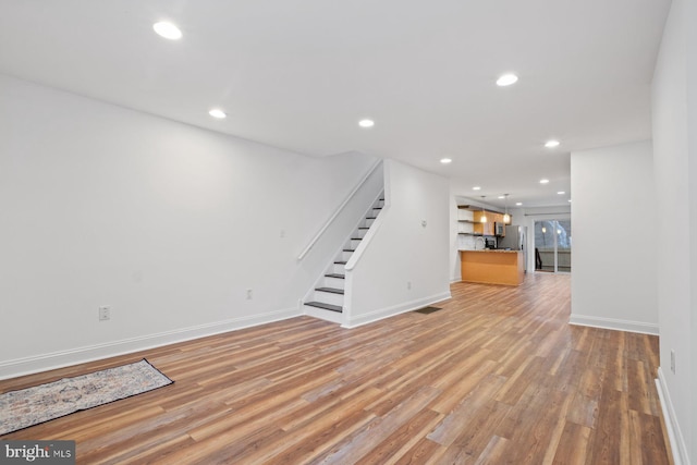 unfurnished living room with light wood-type flooring