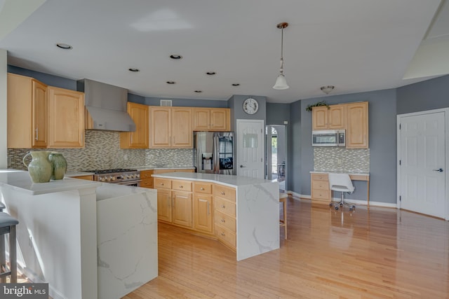 kitchen with backsplash, pendant lighting, stainless steel appliances, a center island, and wall chimney range hood