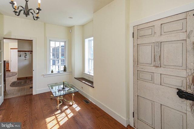 interior space featuring a notable chandelier and dark hardwood / wood-style floors