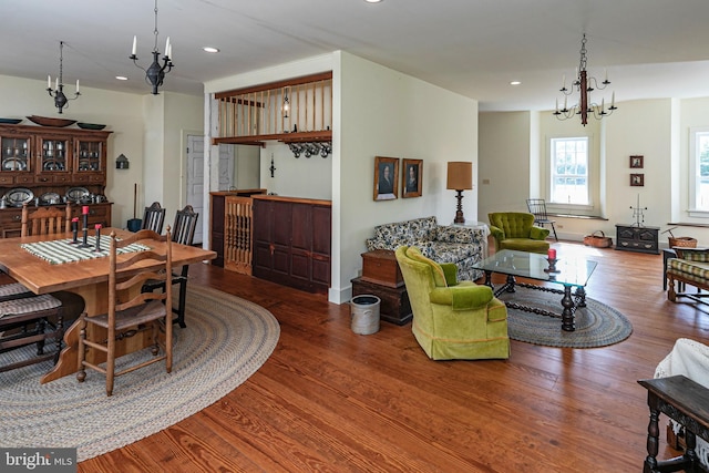 dining room with hardwood / wood-style floors and a notable chandelier