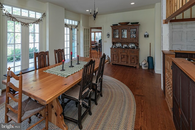 dining room featuring dark hardwood / wood-style floors and an inviting chandelier