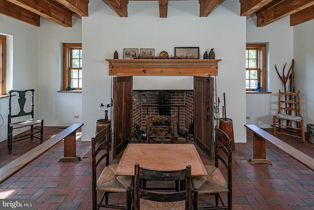 dining space with beam ceiling and a wealth of natural light