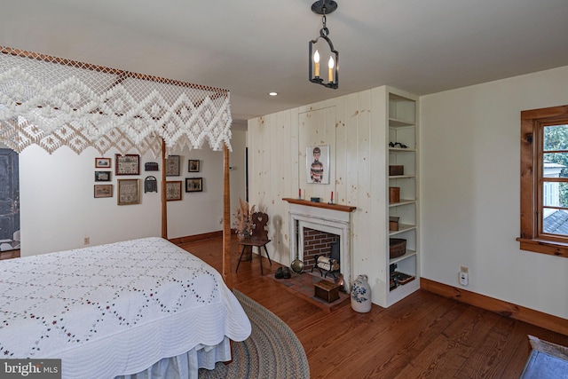 bedroom with dark wood-type flooring and a notable chandelier