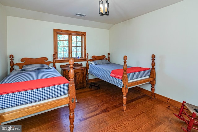 bedroom featuring vaulted ceiling and hardwood / wood-style floors