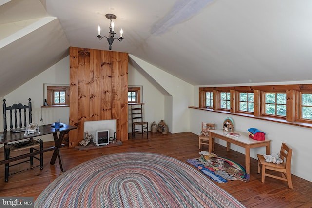 office area featuring lofted ceiling, wood-type flooring, and an inviting chandelier