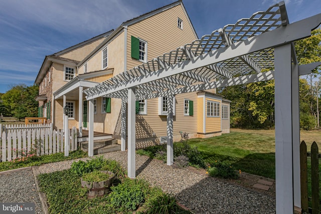 exterior space with a front yard and a pergola