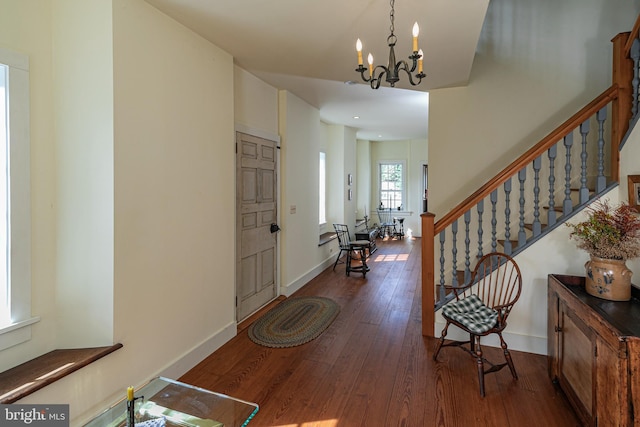 foyer entrance featuring a notable chandelier and dark hardwood / wood-style floors