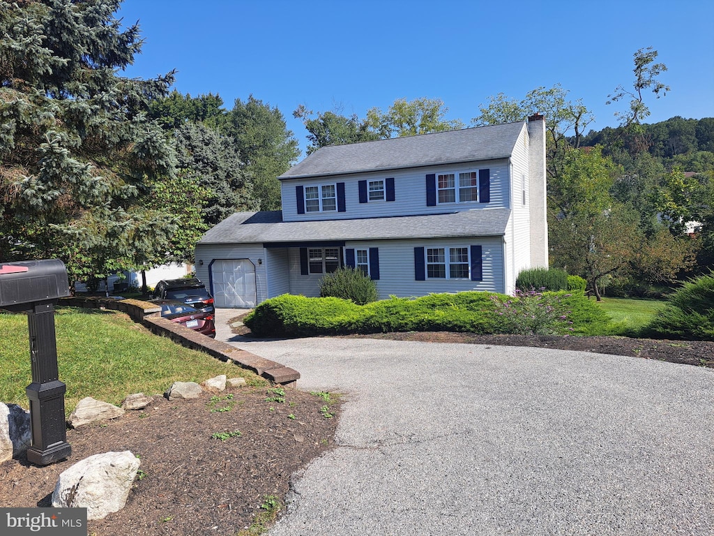 view of front facade with a front yard and a garage