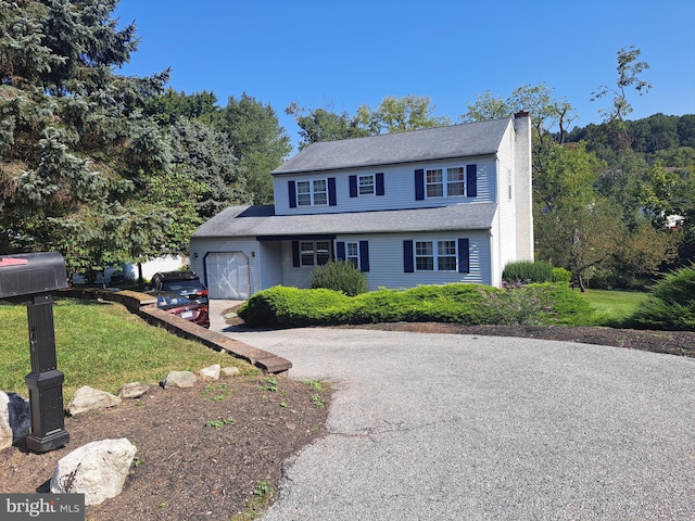 view of front facade with a front yard and a garage