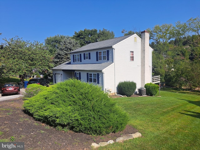 view of property exterior with a lawn and central AC unit