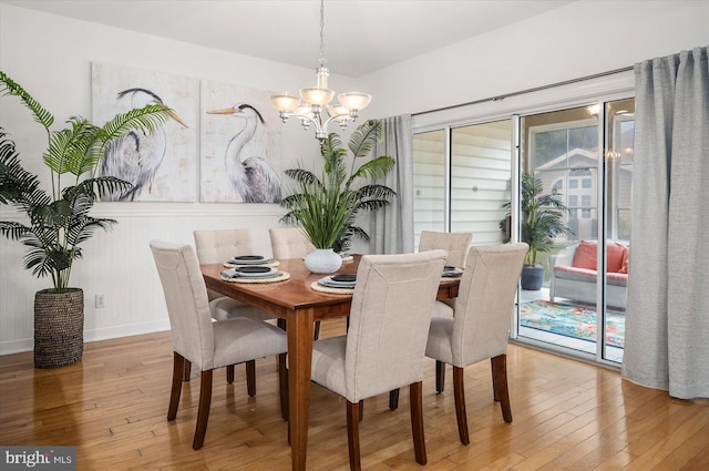 dining room featuring hardwood / wood-style flooring and a notable chandelier