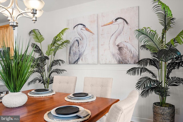 dining area with an inviting chandelier