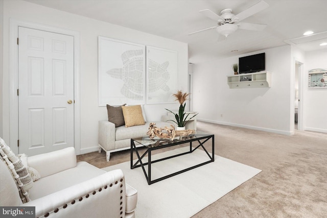 carpeted living room featuring ceiling fan