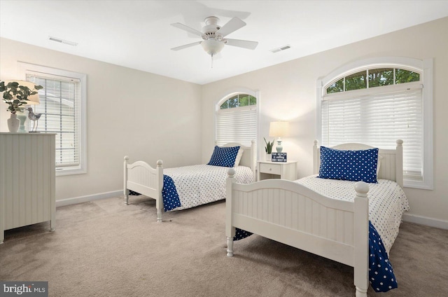 bedroom featuring light carpet and ceiling fan