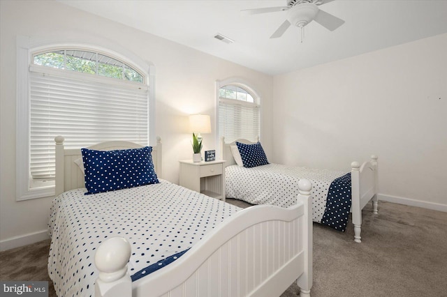 bedroom featuring carpet floors, multiple windows, and ceiling fan