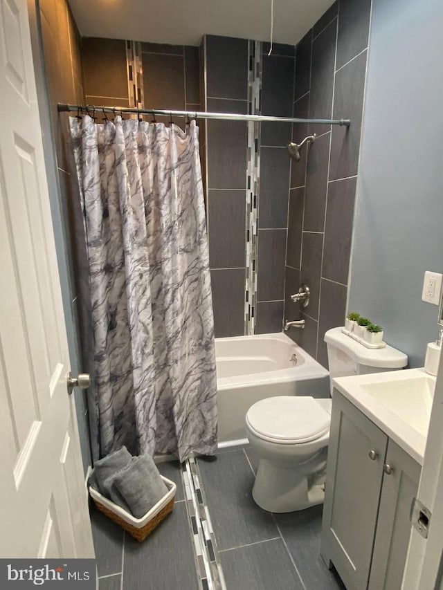 full bathroom with shower / tub combo, vanity, toilet, and tile patterned floors