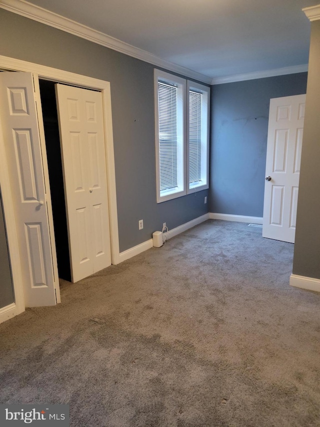 spare room with carpet floors and ornamental molding