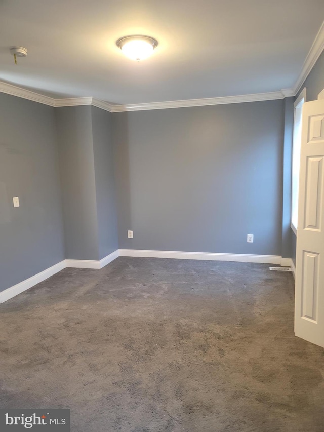 spare room with crown molding and dark carpet