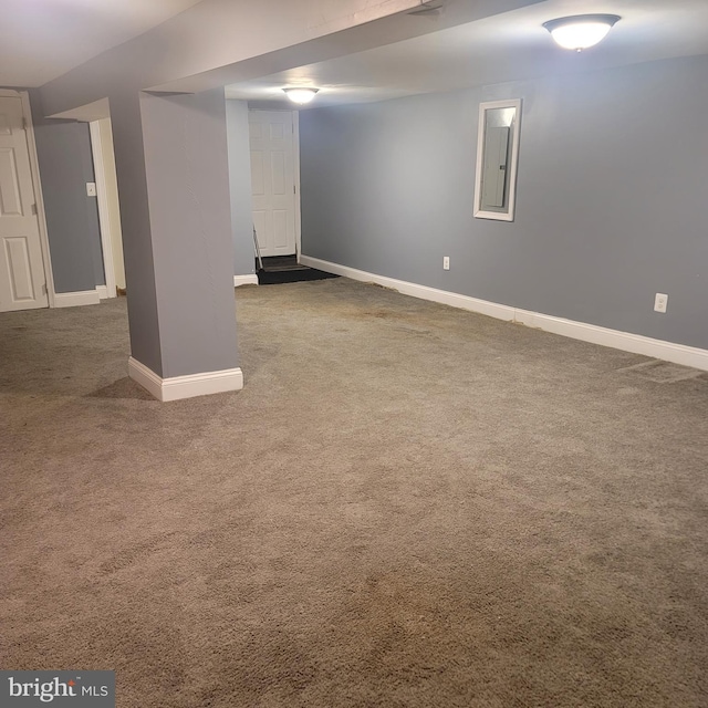 basement with electric panel and dark colored carpet