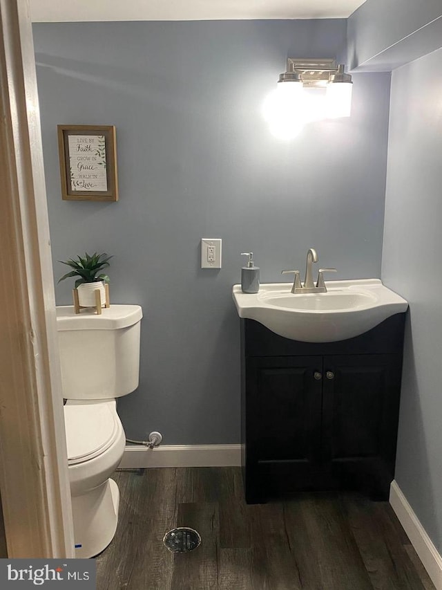 bathroom featuring hardwood / wood-style floors, vanity, and toilet