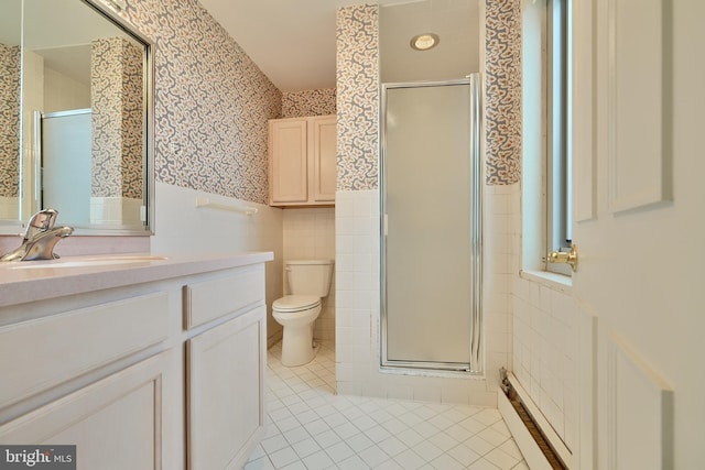 bathroom featuring an enclosed shower, vanity, toilet, and tile walls