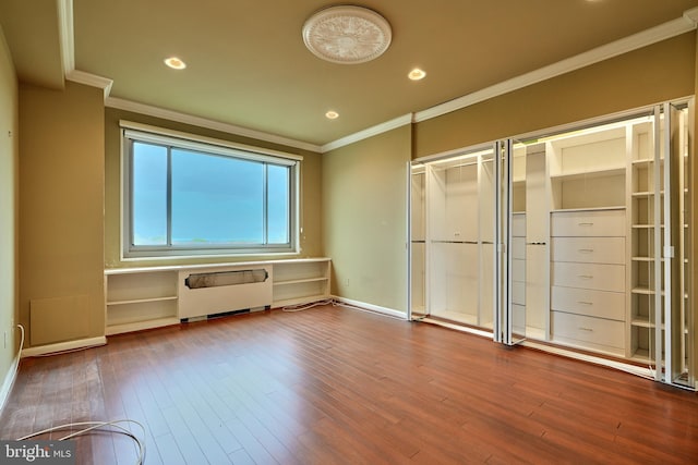 unfurnished bedroom featuring radiator, ornamental molding, and hardwood / wood-style flooring