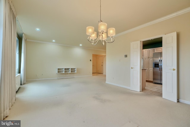 spare room with light carpet, crown molding, and a notable chandelier