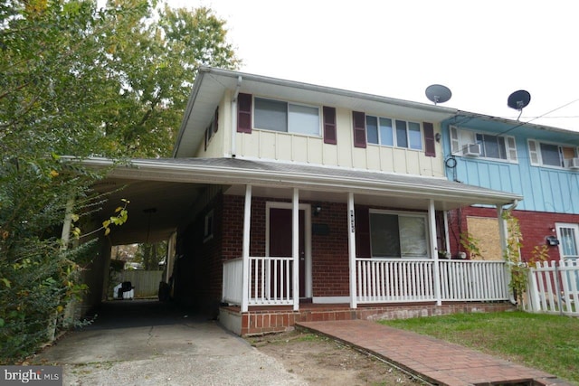 view of front of house with covered porch and a carport