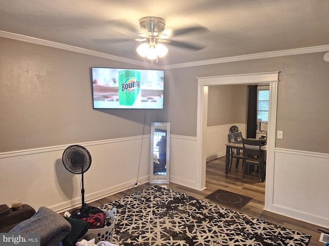 interior space with ornamental molding, ceiling fan, and hardwood / wood-style floors