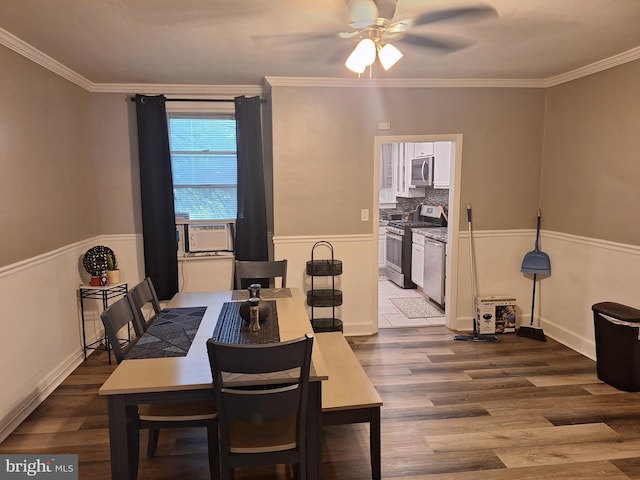 dining space with wood-type flooring, cooling unit, ornamental molding, and ceiling fan