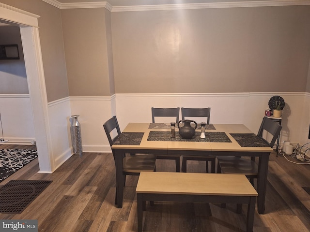 dining area with dark hardwood / wood-style floors and ornamental molding