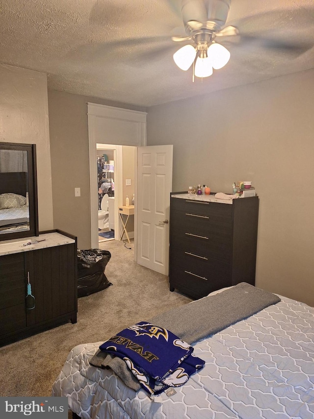 bedroom with ceiling fan, a textured ceiling, and light carpet