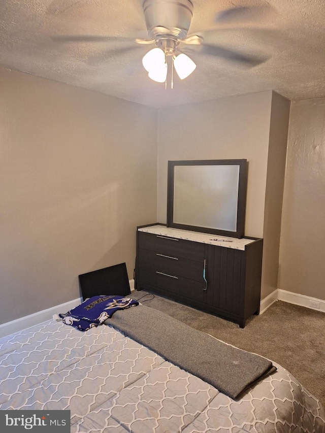 bedroom featuring ceiling fan, carpet flooring, and a textured ceiling