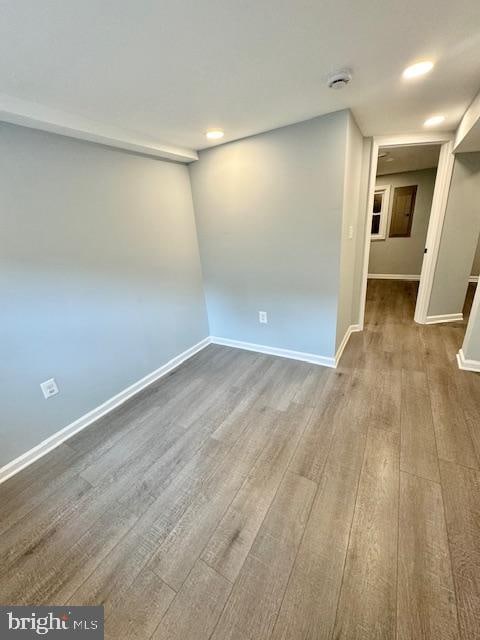 unfurnished room with wood-type flooring